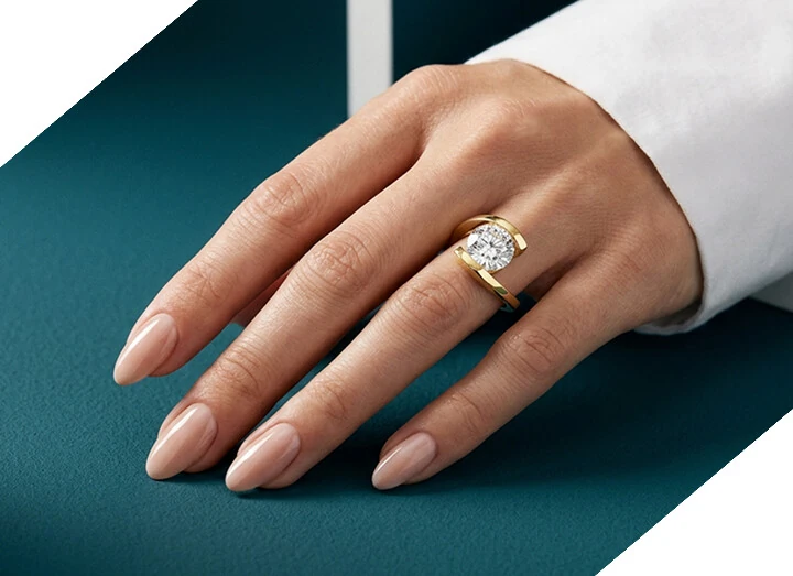 A gold lab-grown diamond ring from HVJ Diamonds worn on the hand