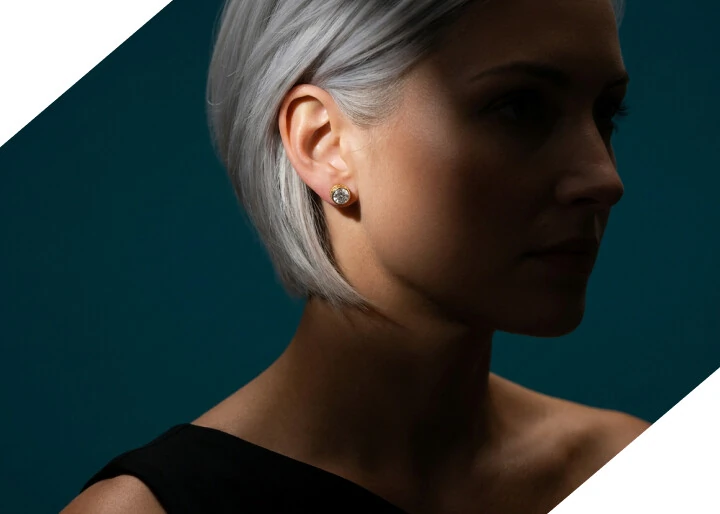 A woman wearing lab-grown diamond stud earrings from HVJ Diamonds