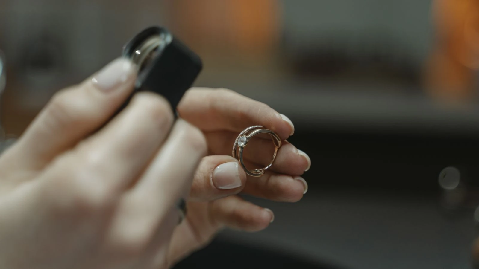 Jeweller inspecting a diamond ring with a magnifier