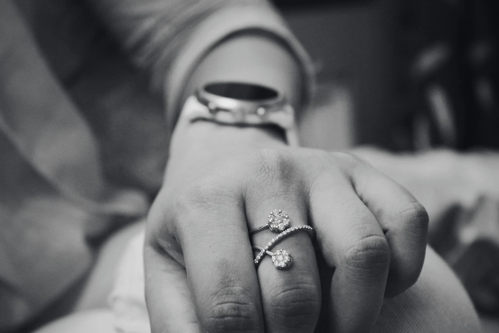 Close-up of a hand wearing a diamond ring, showing everyday wear