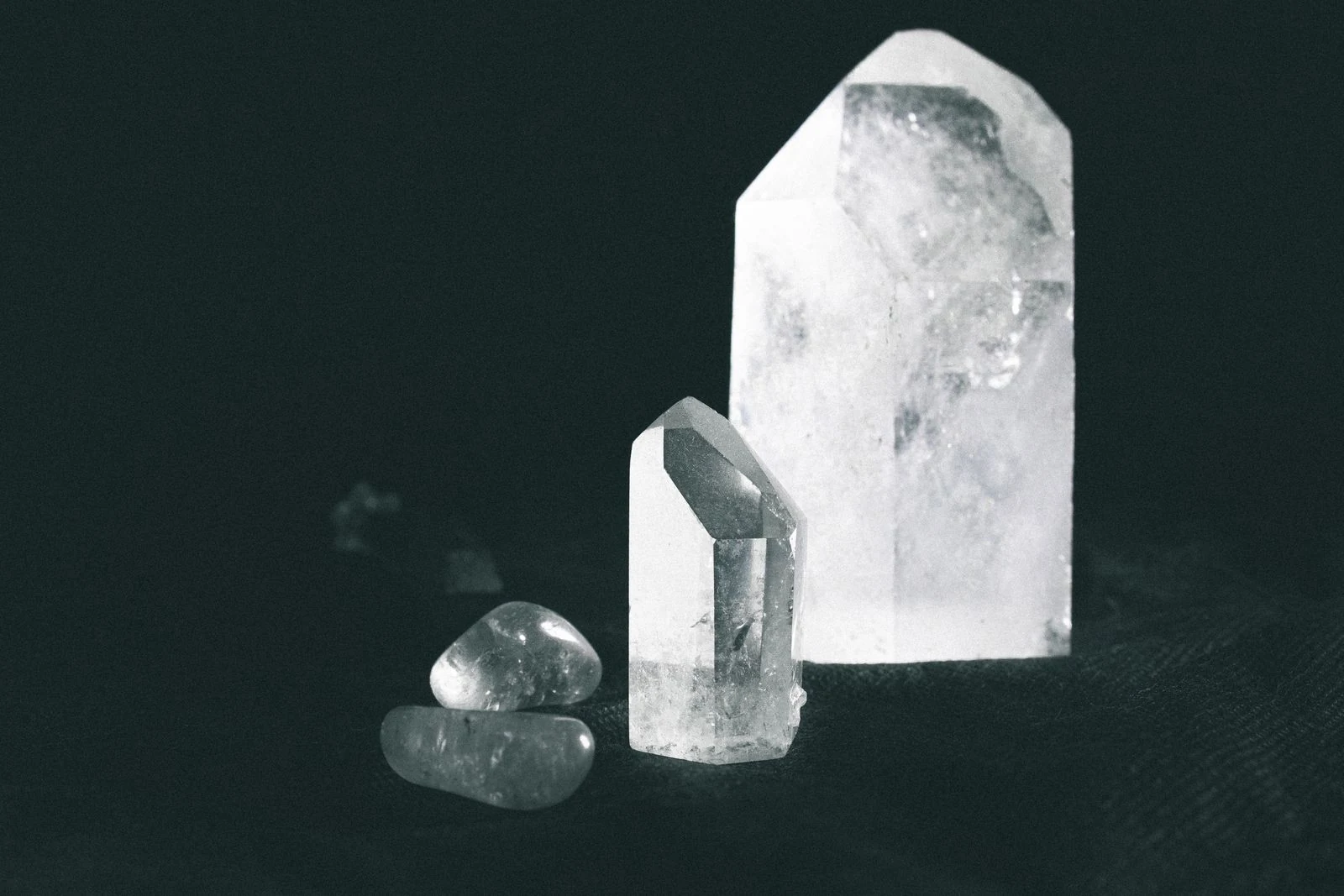 Raw crystals on a dark surface representing natural diamond formation
