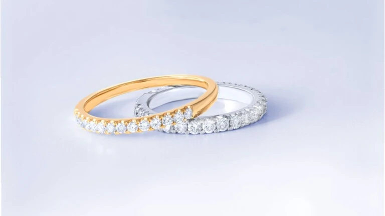 Two diamond rings in gold and silver settings shown side by side